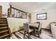 Cozy dining area with room for six chairs and adjacent to the stairwell at 710 S Grand Ave, Fort Lupton, CO 80621