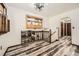 A well-lit hallway with hardwood floors, leading to various rooms and an open staircase at 710 S Grand Ave, Fort Lupton, CO 80621