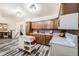 Well-lit kitchen featuring wood cabinets, a kitchen island, and modern appliances at 710 S Grand Ave, Fort Lupton, CO 80621
