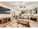 Cozy living room features recessed lighting, wood-look flooring, and comfortable, neutral-toned furniture at 710 S Grand Ave, Fort Lupton, CO 80621