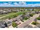 Aerial view showcases a residential neighborhood with manicured lawns, mature trees, and a nearby pond at 5400 S Quail Way, Littleton, CO 80127