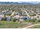 Scenic neighborhood view with lush green lawns and mature trees beneath a beautiful sky at 5400 S Quail Way, Littleton, CO 80127