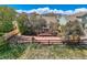 Private fenced backyard featuring mature landscaping and a patio with outdoor seating at 5400 S Quail Way, Littleton, CO 80127