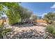 Flagstone patio in the backyard with lush landscaping, a wooden fence, and mature trees at 5400 S Quail Way, Littleton, CO 80127