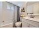 Bright bathroom features a shower-tub combo, floral shower curtain, and a large mirror above the vanity at 5400 S Quail Way, Littleton, CO 80127