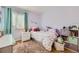 A charming bedroom with vibrant decor, comfortable bedding, and organized storage at 5400 S Quail Way, Littleton, CO 80127