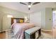 Comfortable bedroom with a ceiling fan, a cozy bed, and a view towards the closet enhances the inviting atmosphere at 5400 S Quail Way, Littleton, CO 80127