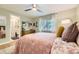 A well-decorated bedroom with natural light streaming in, complemented by a view into the en suite bathroom at 5400 S Quail Way, Littleton, CO 80127