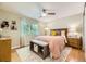 Cozy bedroom with a ceiling fan, a window letting in natural light, and a comfortable bed with stylish bedding at 5400 S Quail Way, Littleton, CO 80127