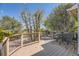 Exterior deck with a brown stain, with metal furniture, overlooking a lush backyard with mature trees at 5400 S Quail Way, Littleton, CO 80127