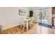 Bright dining area features hardwood floors and a sliding door to the deck, perfect for indoor-outdoor living at 5400 S Quail Way, Littleton, CO 80127