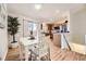 Charming dining space that flows to kitchen, featuring hardwood floors and natural light from the patio doors at 5400 S Quail Way, Littleton, CO 80127