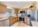 Modern kitchen featuring stainless steel appliances, ample counter space, and warm wood cabinetry for a stylish and functional cooking space at 5400 S Quail Way, Littleton, CO 80127