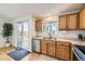 Kitchen featuring stainless steel appliances, a sink with a view, and a sliding glass door leading to the deck at 5400 S Quail Way, Littleton, CO 80127