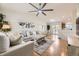 Bright living area with a soaring ceiling, featuring hardwood floors and a modern ceiling fan at 5400 S Quail Way, Littleton, CO 80127