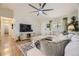 Comfortable living area featuring a vaulted ceiling, hardwood floors, and modern furnishings for cozy and chic living at 5400 S Quail Way, Littleton, CO 80127