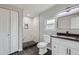 Modern bathroom featuring a tiled walk-in shower, black fixtures, and a sleek vanity with black countertops at 6880 Pontiac St, Commerce City, CO 80022