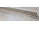 Light gray wood-look vinyl flooring gives a modern and clean design aesthetic at 6880 Pontiac St, Commerce City, CO 80022