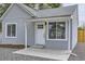 Charming home featuring a quaint front entrance with a white door, fresh paint, and tasteful landscaping at 6880 Pontiac St, Commerce City, CO 80022