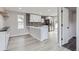 Bright kitchen with stainless steel appliances, white cabinets, decorative backsplash, and an eat-in island at 6880 Pontiac St, Commerce City, CO 80022