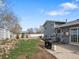 Backyard with a well-maintained lawn, partial rock garden, concrete patio, fence and blue home exterior at 19093 W 61St Pl, Golden, CO 80403