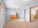 Open basement with light blue walls, carpet flooring, stairs, wood cabinet and closet with access to laundry area at 19093 W 61St Pl, Golden, CO 80403