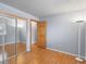 Bedroom with hardwood floors, mirrored closet, and neutral paint at 19093 W 61St Pl, Golden, CO 80403