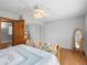 Bedroom featuring hardwood floors, ceiling fan, bed, and two large windows at 19093 W 61St Pl, Golden, CO 80403