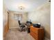 Bedroom featuring neutral colored walls, carpet flooring, closet, and an office setup for work at 19093 W 61St Pl, Golden, CO 80403