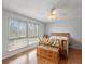 Bright bedroom with hardwood floors, ceiling fan, and two large windows at 19093 W 61St Pl, Golden, CO 80403