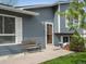 Inviting home exterior with a cozy bench, decorative lighting, and well-kept landscaping at 19093 W 61St Pl, Golden, CO 80403
