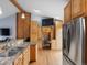 Spacious kitchen with granite counters, wooden cabinets, stainless appliances, and a built-in workspace at 19093 W 61St Pl, Golden, CO 80403
