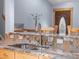 Close up of kitchen sink, tile backsplash, granite counters, and stainless steel faucet at 19093 W 61St Pl, Golden, CO 80403