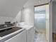 Laundry room with white washer and dryer, as well as access to shower in the bathroom at 19093 W 61St Pl, Golden, CO 80403