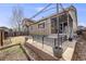 Backyard with a covered patio area, a small grassy lawn, and garden beds at 12677 Fisher Dr, Englewood, CO 80112