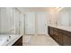 Bathroom with glass shower and double vanity with dark cabinets at 12677 Fisher Dr, Englewood, CO 80112
