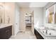 Bright bathroom features a soaking tub, double sink vanity, and doorway to the Primary bedroom at 12677 Fisher Dr, Englewood, CO 80112