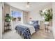 Bedroom with large window, ceiling fan, and neutral carpet at 12677 Fisher Dr, Englewood, CO 80112