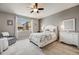 Comfortable bedroom with neutral walls, ceiling fan and large window for lots of natural light at 12677 Fisher Dr, Englewood, CO 80112