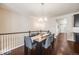 Inviting dining area with a modern chandelier, stylish seating, and an open view to the living space at 12677 Fisher Dr, Englewood, CO 80112