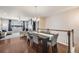 Open-concept dining area adjacent to living room with hardwood floors and plenty of natural light at 12677 Fisher Dr, Englewood, CO 80112