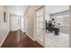 Welcoming foyer with hardwood floors leads to a bright office with glass doors and neutral decor at 12677 Fisher Dr, Englewood, CO 80112