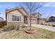 Well maintained house features neutral siding, stone accents, a two-car garage, and manicured front yard at 12677 Fisher Dr, Englewood, CO 80112