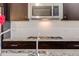 Kitchen range with stainless steel microwave and granite countertops at 12677 Fisher Dr, Englewood, CO 80112