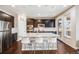 Contemporary kitchen featuring dark cabinets, granite countertops, and a spacious island with bar stools at 12677 Fisher Dr, Englewood, CO 80112