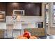 Kitchen bar with seating and stainless appliances at 12677 Fisher Dr, Englewood, CO 80112