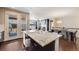 Open kitchen with a large island, view of the dining area, and abundant natural light from nearby windows at 12677 Fisher Dr, Englewood, CO 80112