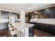 Elegant kitchen with stainless steel appliances, granite counters, and a large island with seating at 12677 Fisher Dr, Englewood, CO 80112