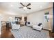 Open-concept living space with a sleek sofa, patterned rug, and views into the modern kitchen at 12677 Fisher Dr, Englewood, CO 80112