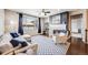 Inviting living room with a cozy fireplace, large window, and stylish blue and white rug at 12677 Fisher Dr, Englewood, CO 80112